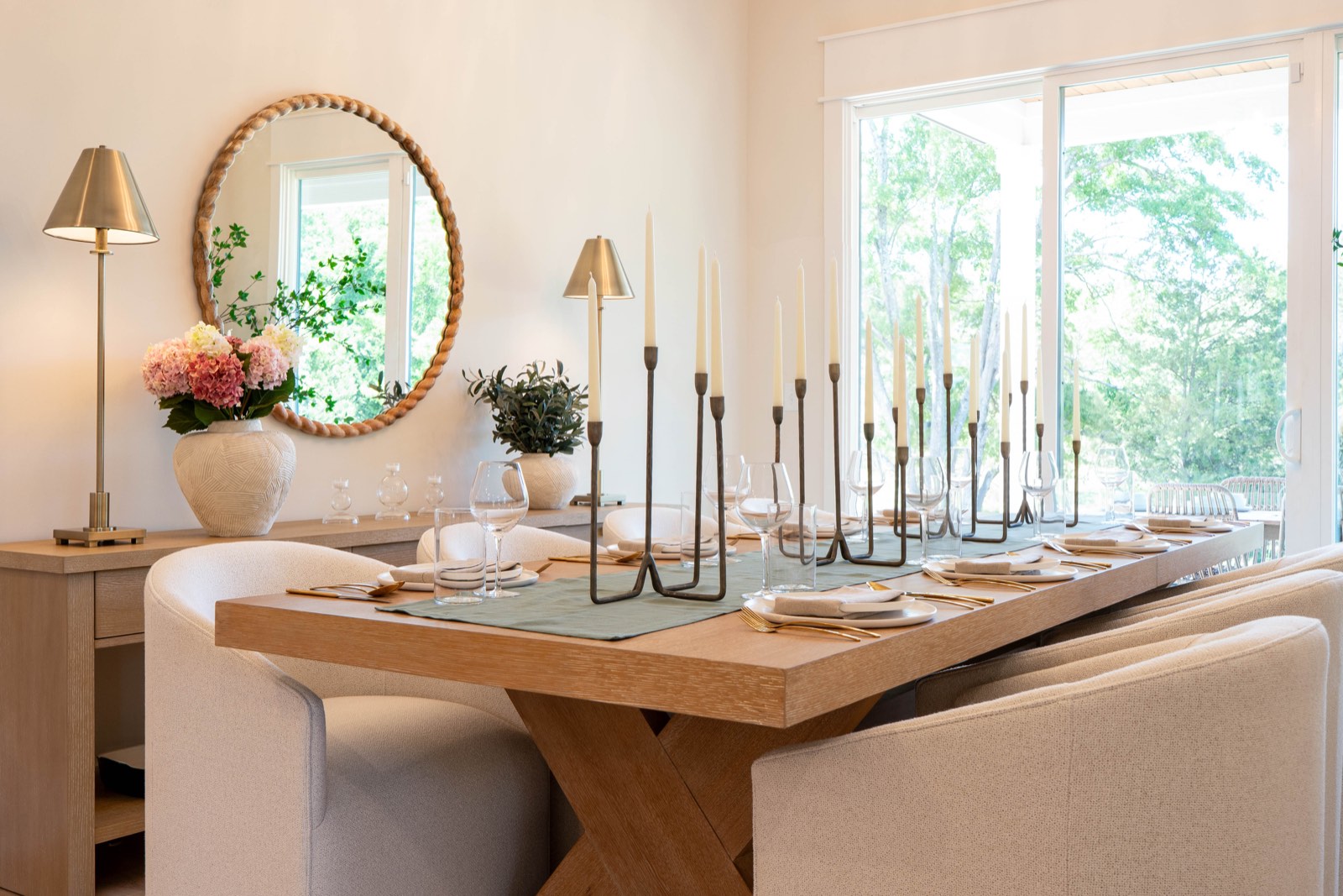 Galley kitchen with sage green cabinetry and brass hardware