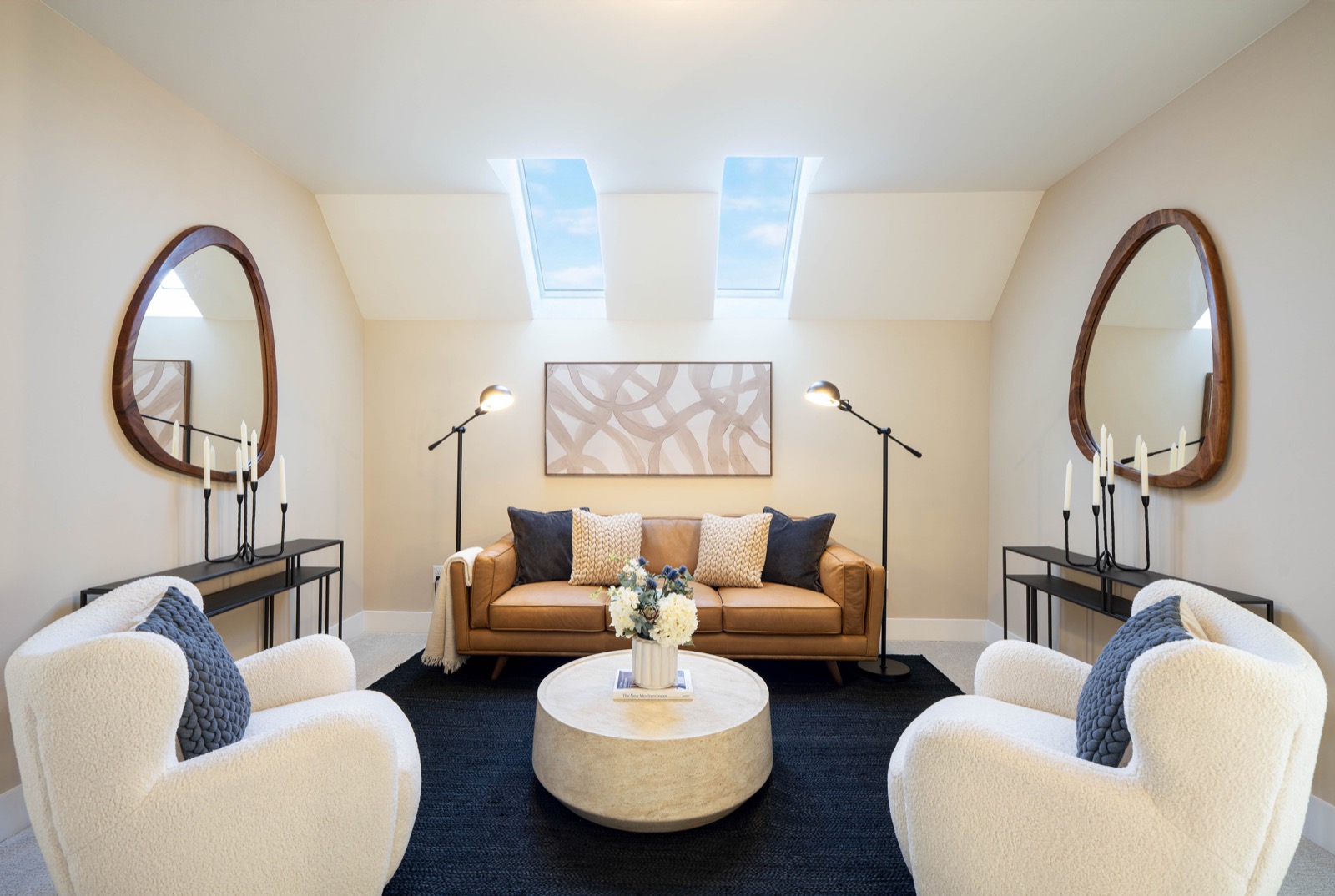 Symmetrical lounge with camel leather sofa and paired swivel chairs
