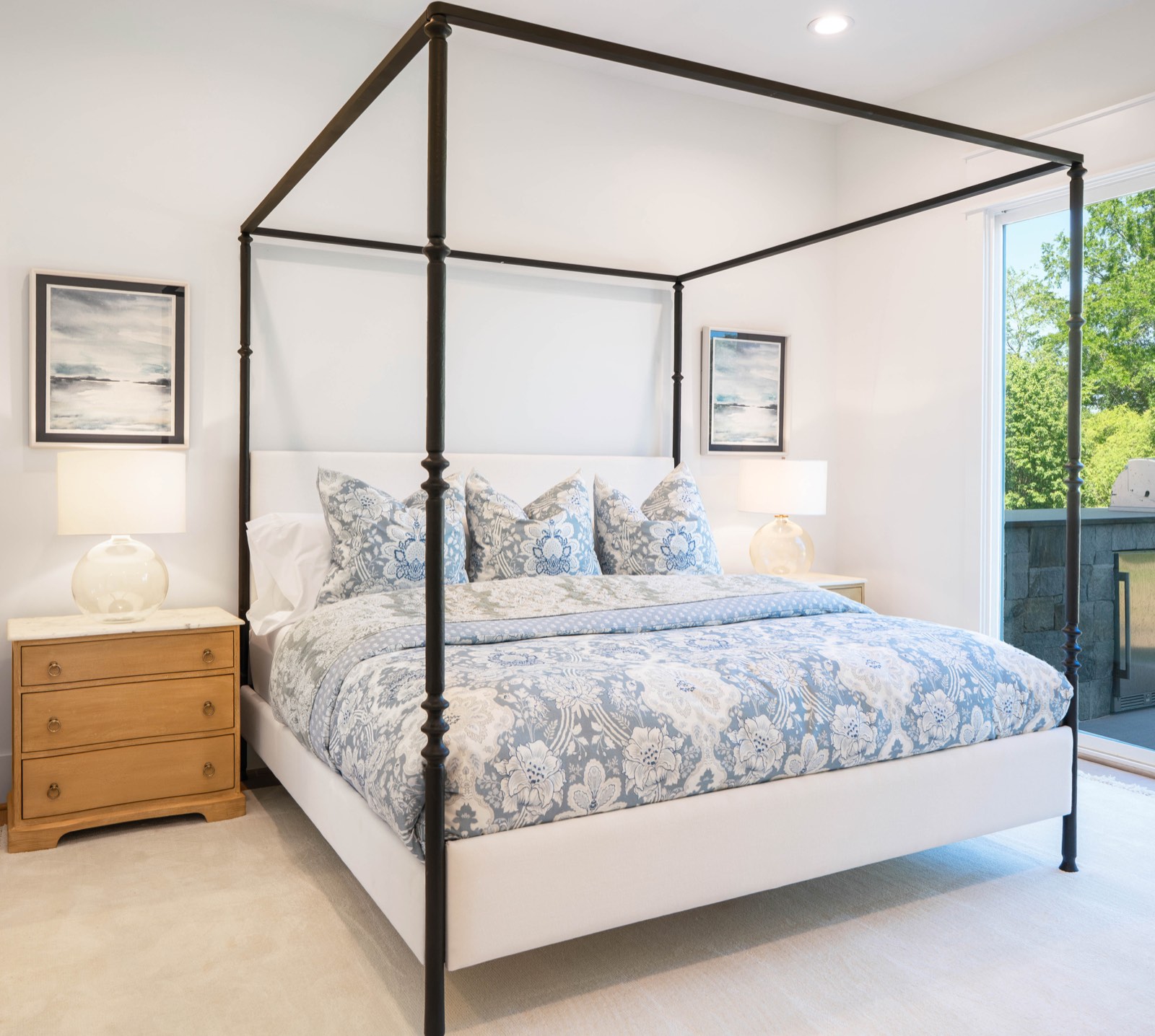 Bedroom with iron canopy bed and floral bedding
