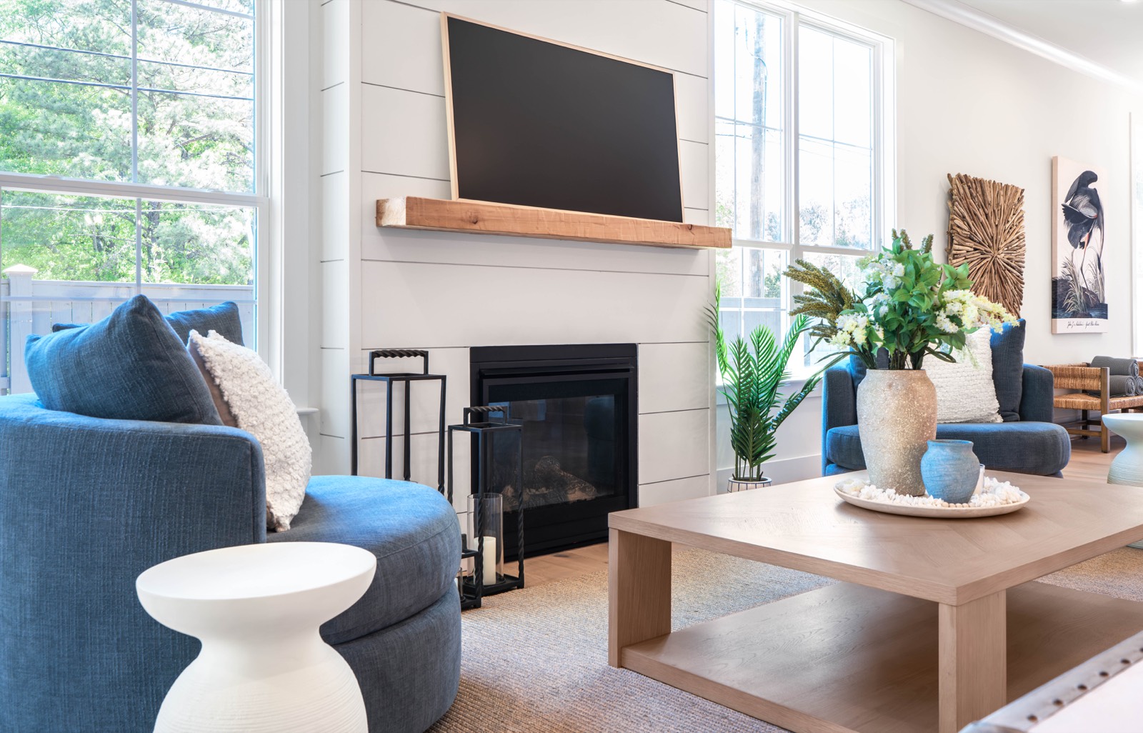 Living room with shiplap fireplace and blue accent seating